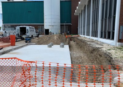 Construction outside of Administrative Building and smokestack