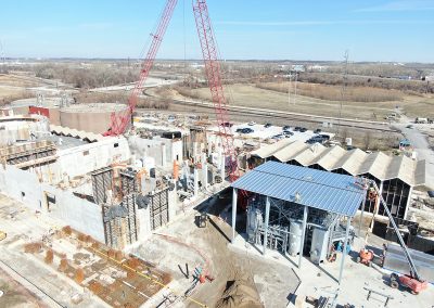 An aerial view of site construction progress and vertical development on building structures.